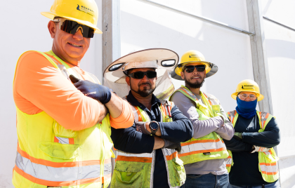 Three men and one woman in PPE